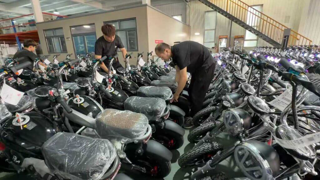Jimsen workers checking electric two-wheelers in the production area