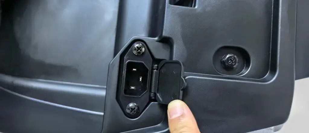 Close-up of the charging connection and access panel on a Jimsen X3